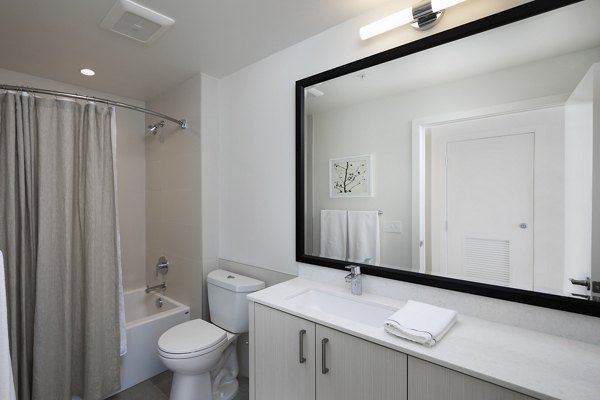 Bathroom featuring modern fixtures and sleek design at Helm Apartments