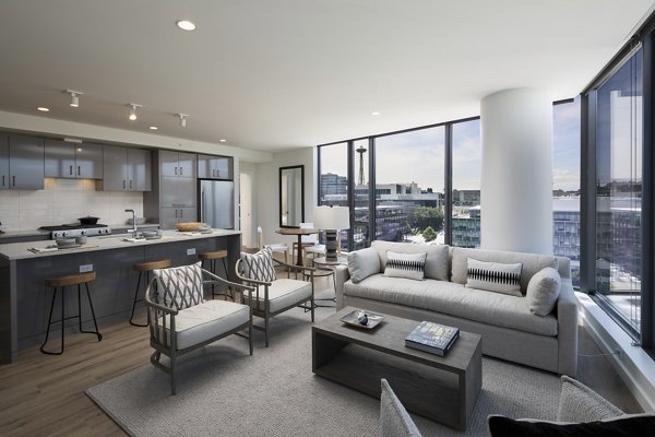 Spacious living room with modern decor and large windows in Helm Apartments