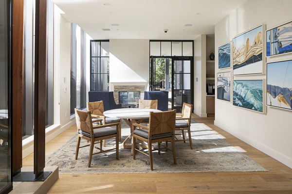 Modern clubhouse featuring lounge seating and entertainment options at Mera Apartments