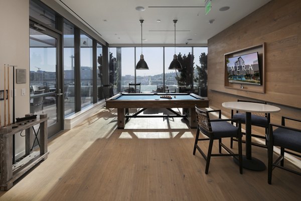 Game room with billiards and seating at Mera Apartments