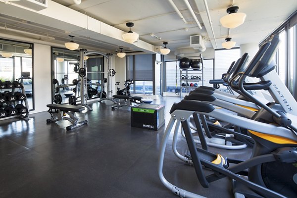 Modern fitness center featuring cutting-edge equipment at Mera Apartments, enhancing active lifestyles and wellness for residents