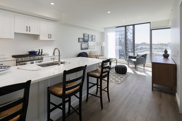 Kitchen featuring modern appliances and granite countertops in Mera Apartments