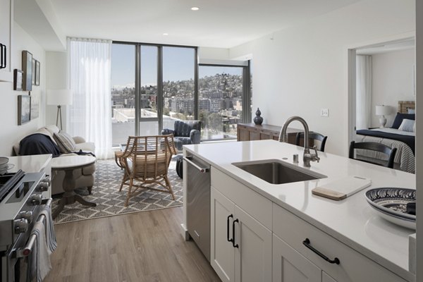 Contemporary kitchen with stainless steel appliances in Mera Apartments