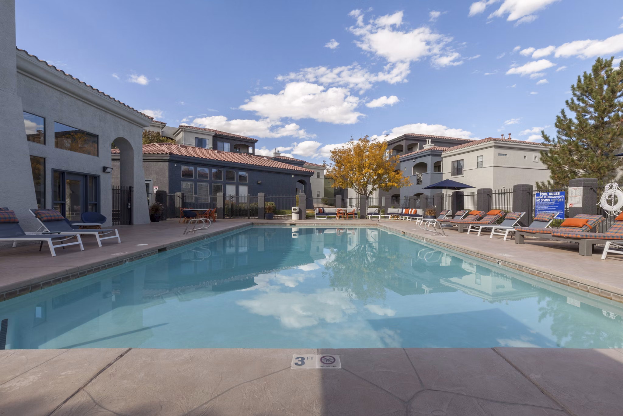 Luxurious pool area with chaise lounges at Circ Apartments, ideal for relaxation and leisure