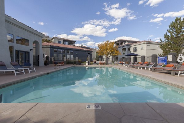 Luxurious pool area with chaise lounges at Circ Apartments, ideal for relaxation and leisure
