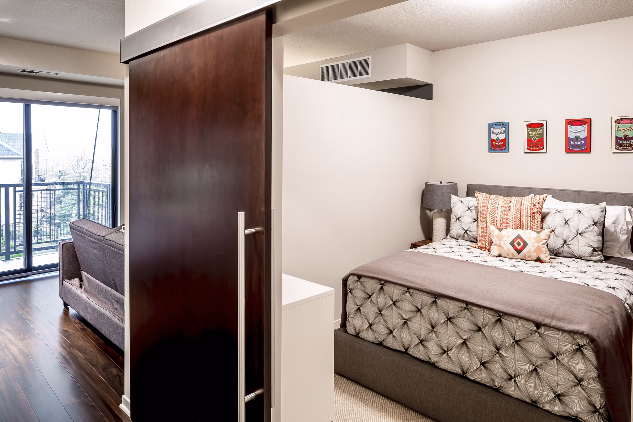 Modern bedroom with sleek furnishings at The Paxon Apartments, offering luxury living in a desirable urban location