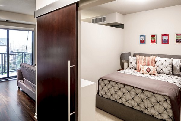 Modern bedroom with sleek furnishings at The Paxon Apartments, offering luxury living in a desirable urban location