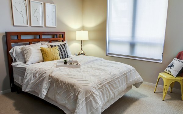 The Paxon Apartments: Modern bedroom with sleek design and ample natural light