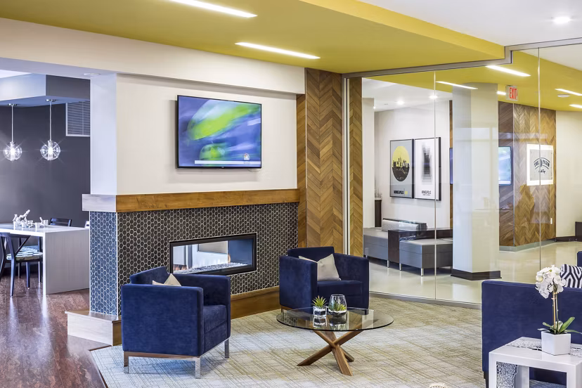 Clubhouse featuring modern interior design with communal gathering spaces at The Paxon Apartments