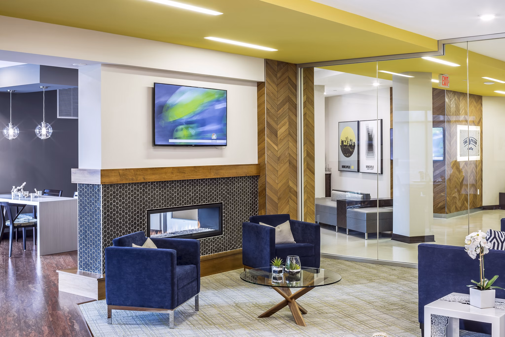 Clubhouse featuring modern interior design with communal gathering spaces at The Paxon Apartments