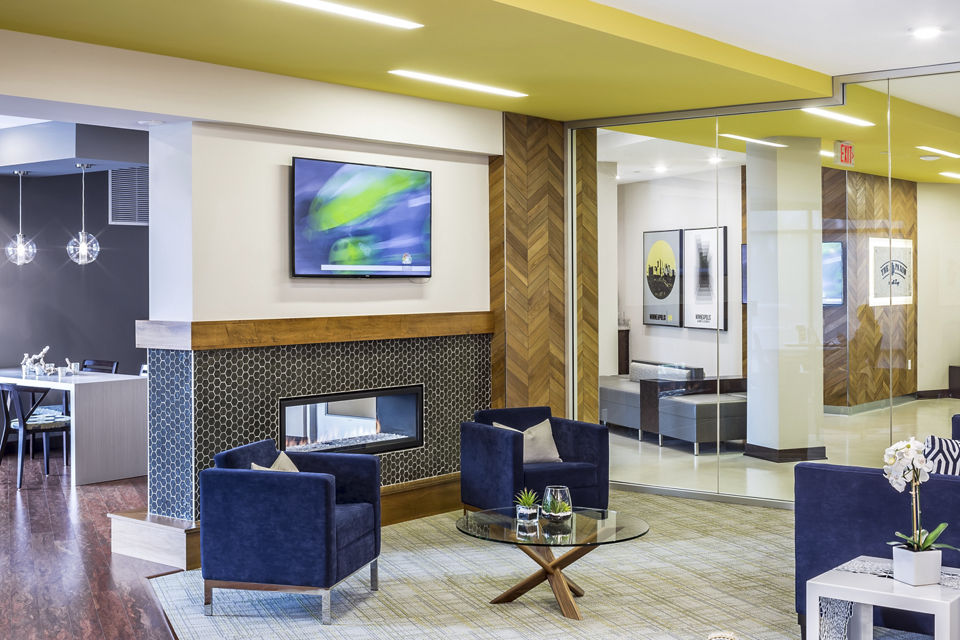 Clubhouse featuring modern interior design with communal gathering spaces at The Paxon Apartments