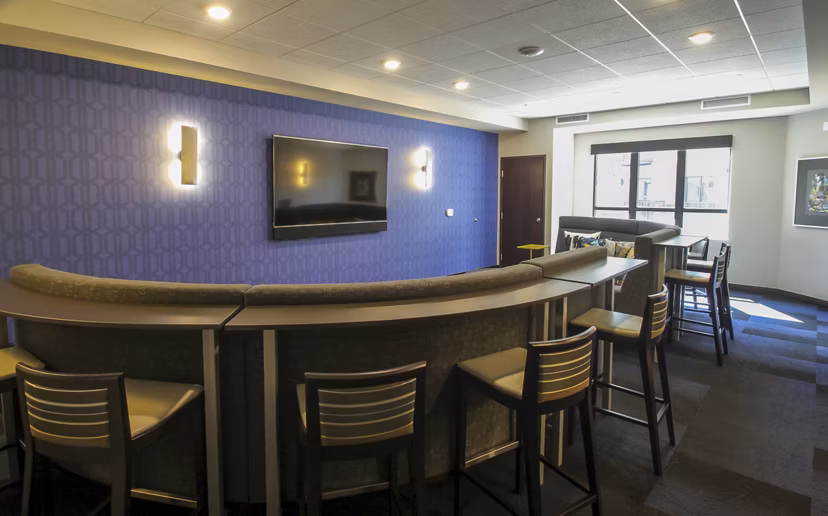 Cozy theater room with plush seating at The Paxon Apartments, offering a premium movie-watching experience for residents