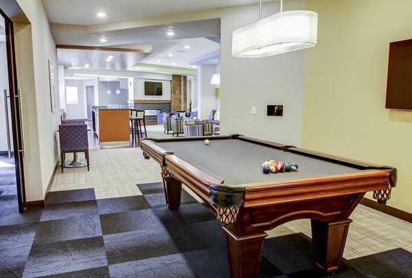 Game room with billiards and lounge seating at The Paxon Apartments