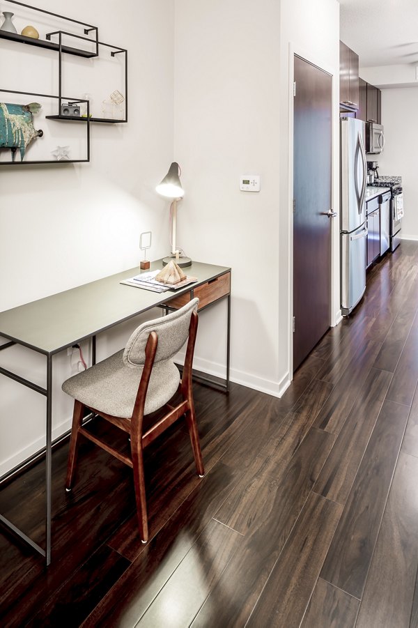 Elegant kitchen with granite countertops and stainless-steel appliances in The Paxon Apartments