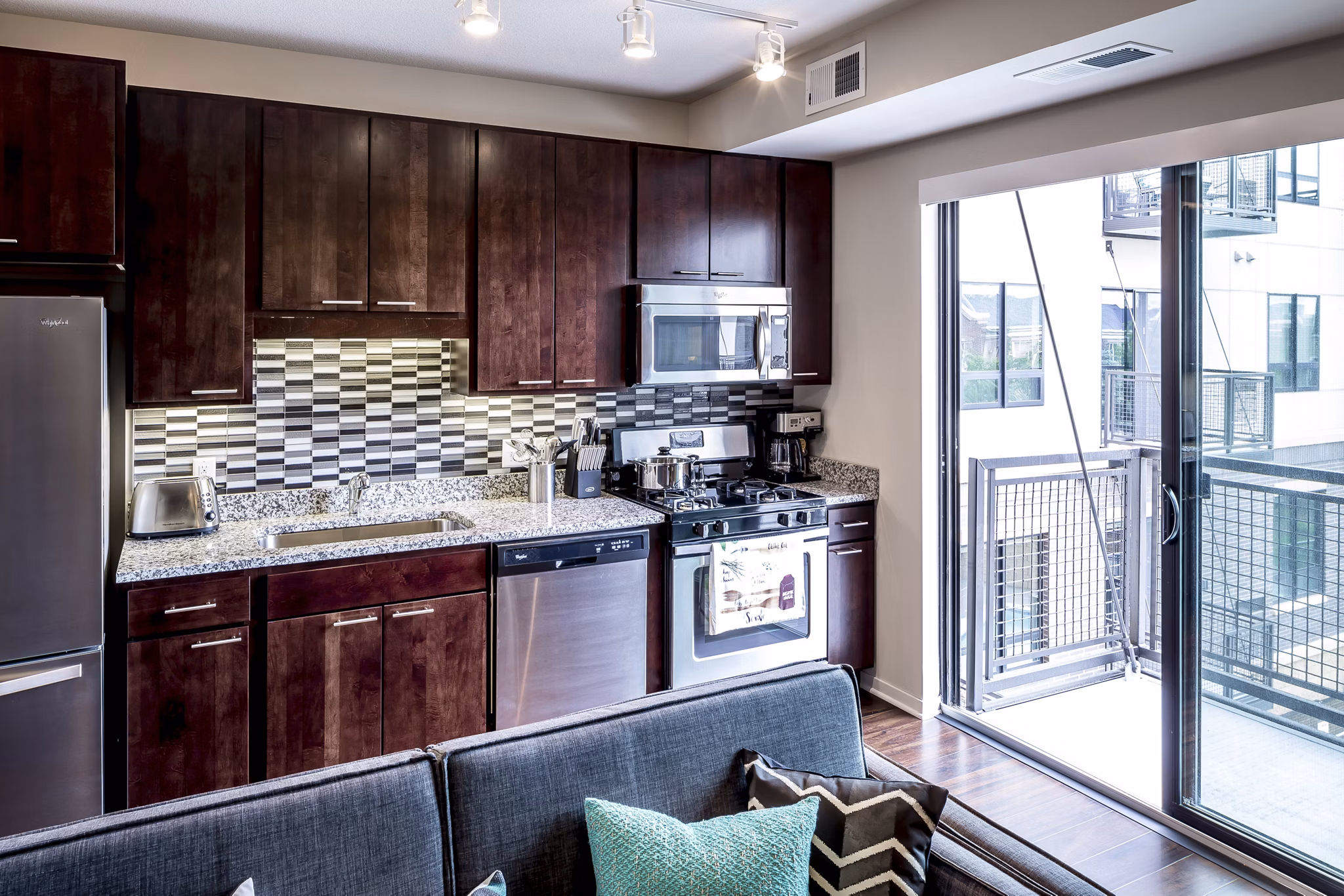 Modern kitchen with stainless steel appliances at The Paxon Apartments