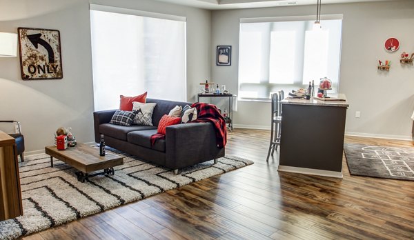 Spacious living room with modern decor and ample natural light in The Paxon Apartments, Greystar luxury apartment community