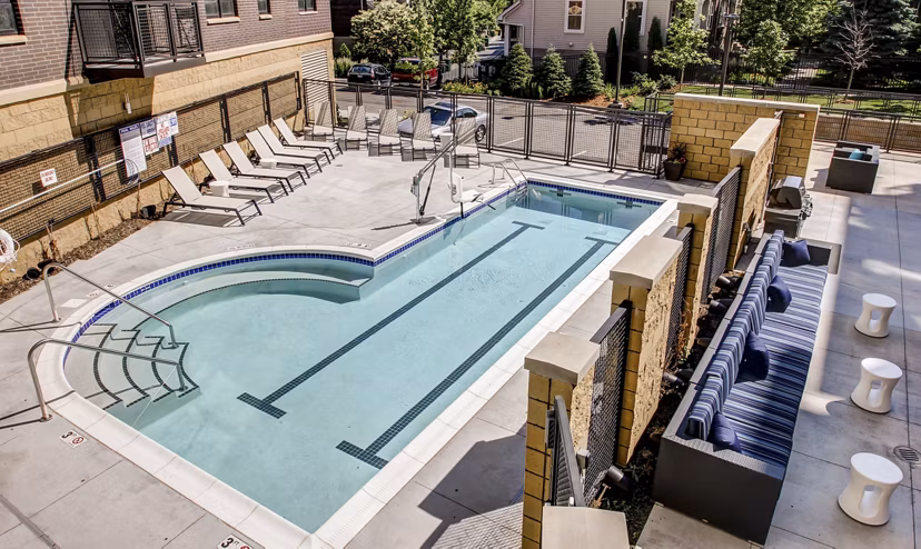 Inviting pool with lounge seating at The Paxon Apartments, perfect for relaxation and socializing in a luxury setting