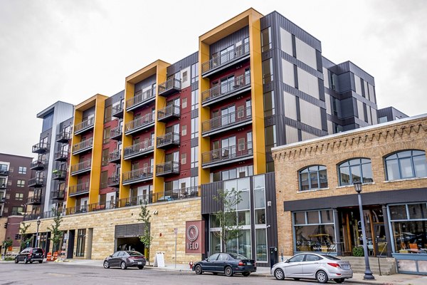 Velo Apartments: Modern building with sleek design in vibrant city setting