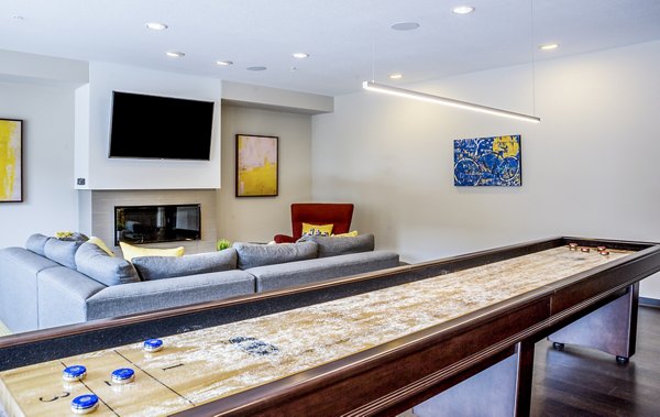 Game room featuring pool tables and foosball at Velo Apartments