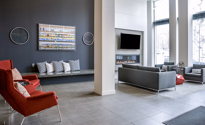 Lobby area featuring modern decor and cozy seating in Velo Apartments luxury clubhouse