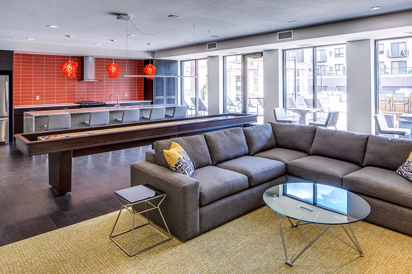 Clubhouse game room with modern decor and pool table at Velo Apartments