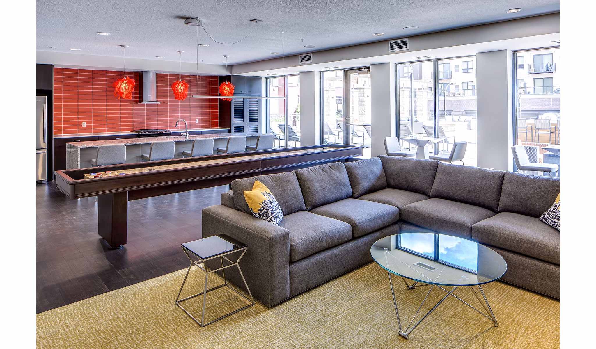 Clubhouse game room with modern decor and pool table at Velo Apartments