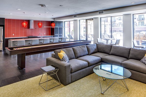 Clubhouse game room with modern decor and pool table at Velo Apartments