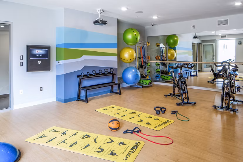 Yoga/spin studio featuring advanced equipment at Velo Apartments