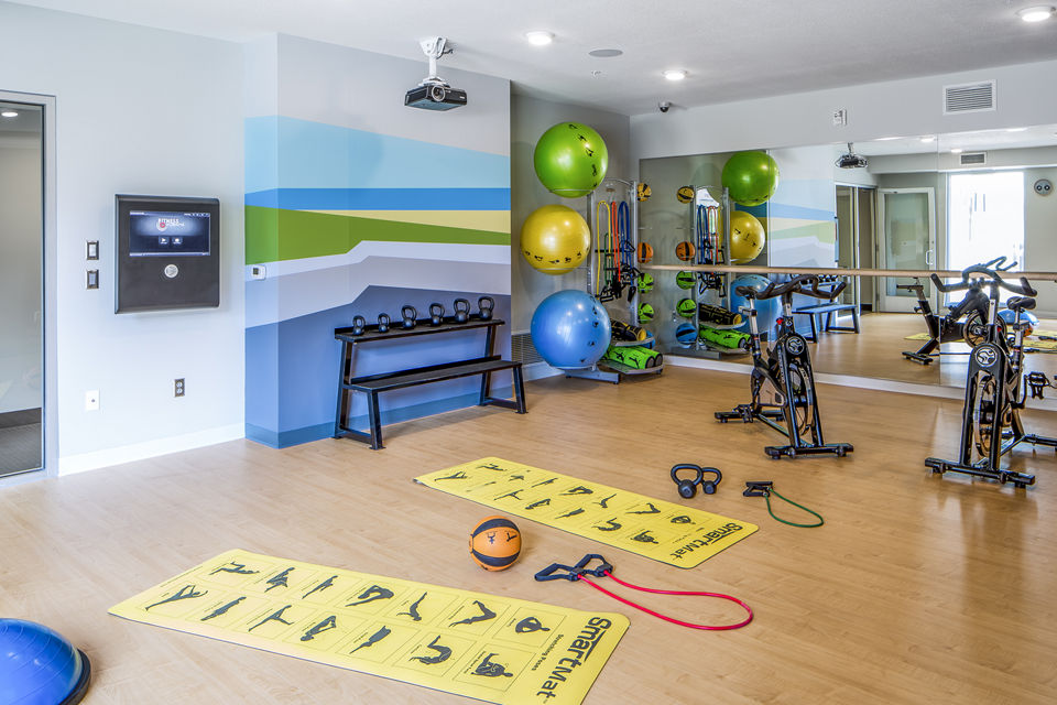 Yoga/spin studio featuring advanced equipment at Velo Apartments
