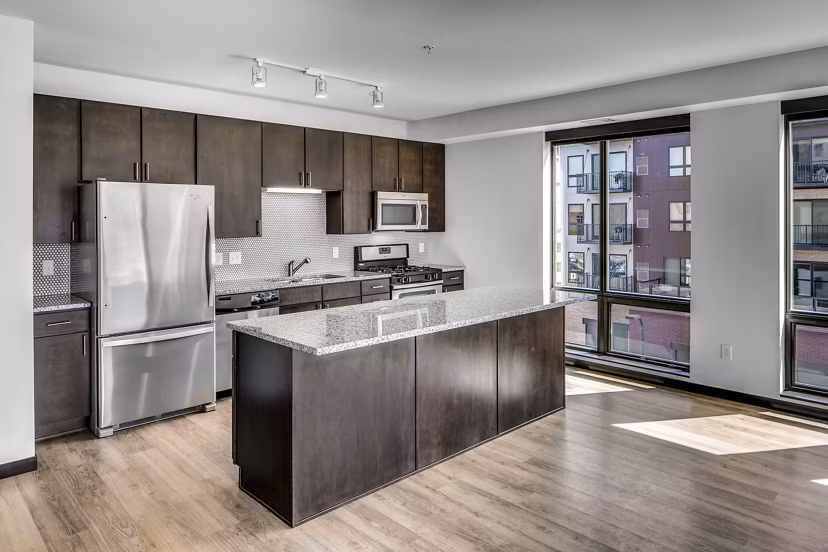 Modern kitchen with stainless steel appliances in Velo luxury apartments