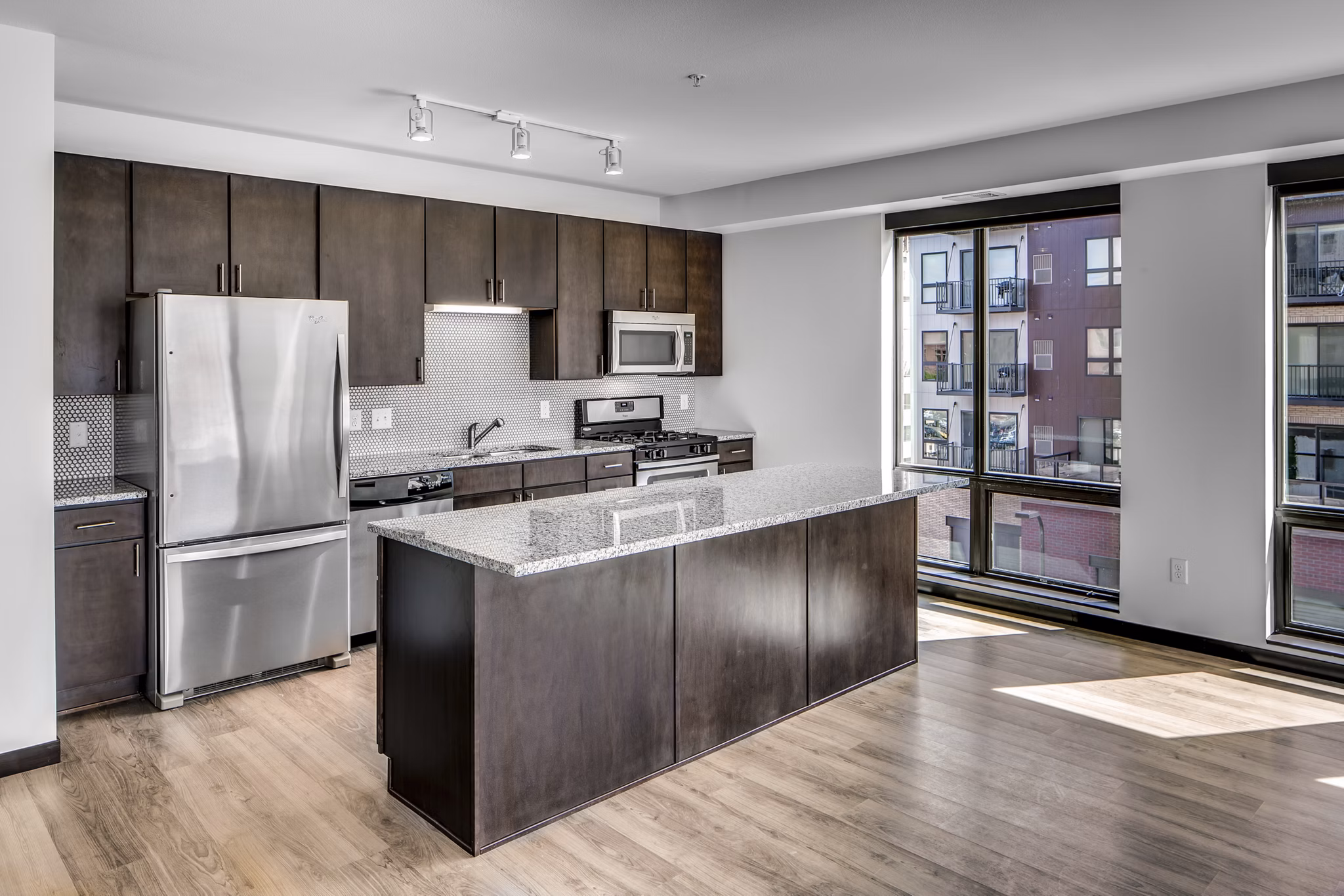 Modern kitchen with stainless steel appliances in Velo luxury apartments