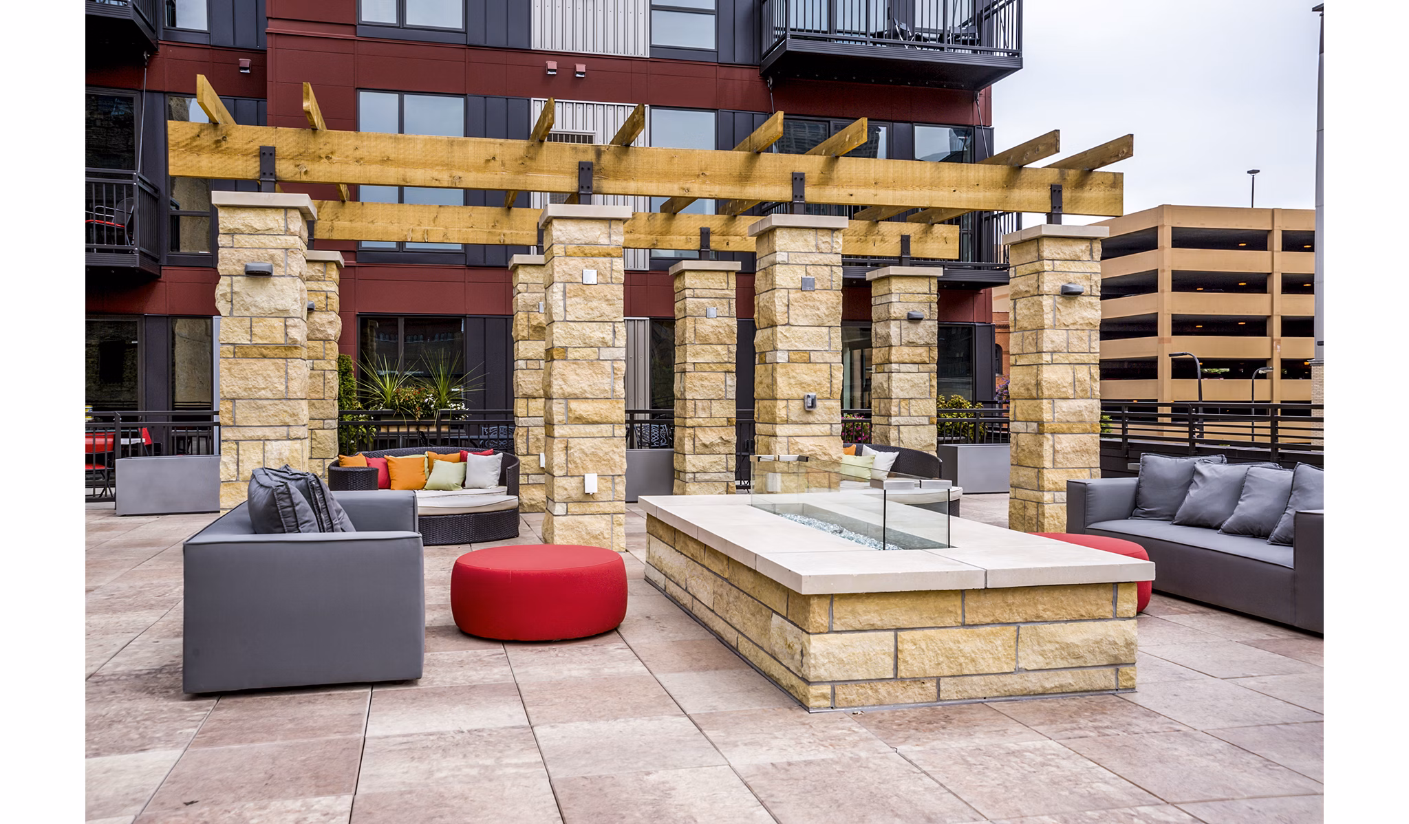Fire pit surrounded by modern seating at Velo Apartments patio offering luxury outdoor living spaces