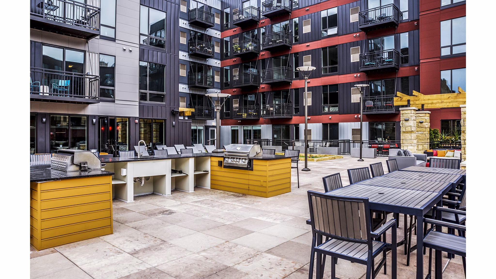 Outdoor grill area with modern seating at Velo Apartments, sustainable luxury living in urban location