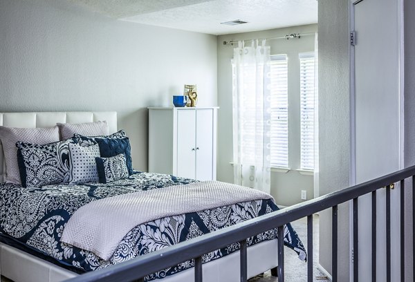 Cozy bedroom with modern furnishings at Spring Park Apartments