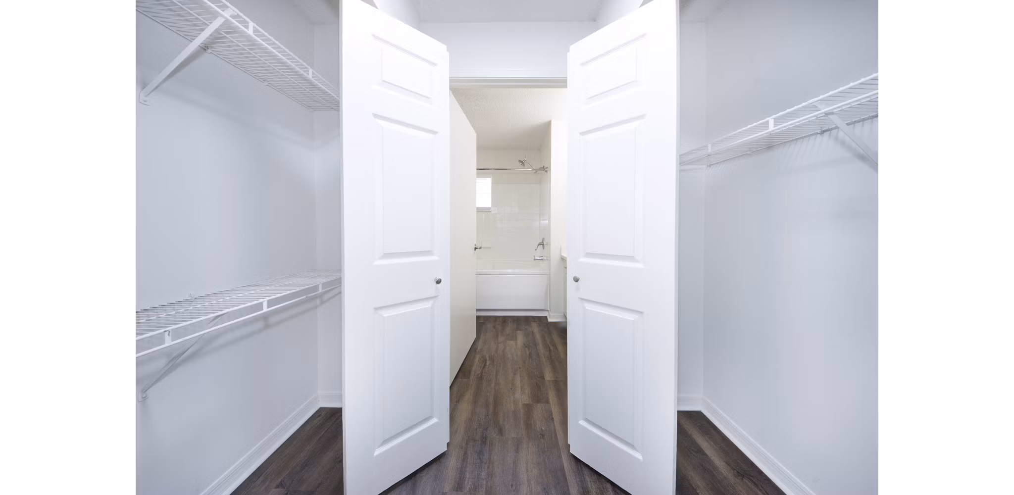 Spacious bedroom closet with customizable shelving at Mira Flores Apartments, luxury residential property by Greystar