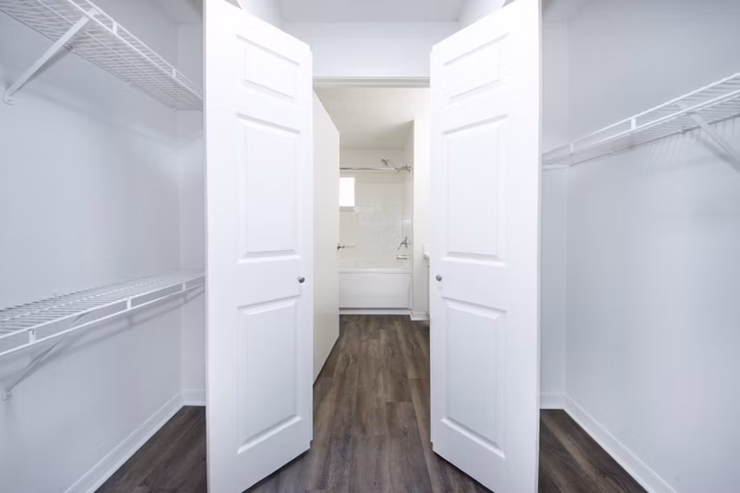 Spacious bedroom closet with customizable shelving at Mira Flores Apartments, luxury residential property by Greystar