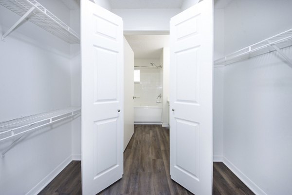Spacious bedroom closet with customizable shelving at Mira Flores Apartments, luxury residential property by Greystar
