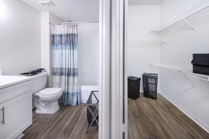 Cozy bedroom with modern decor at Mira Flores Apartments, luxury living in Paml Beach Gardens, FL.