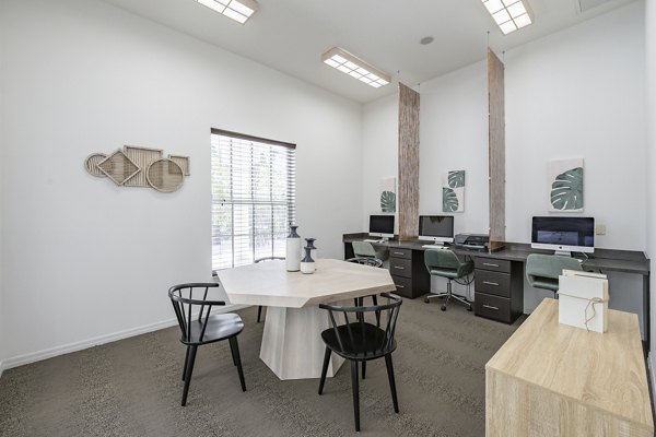 Business center with modern workstations at Mira Flores Apartments