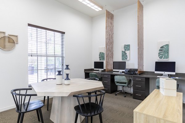Business center with modern workstations at Mira Flores Apartments, providing a professional setting for residents