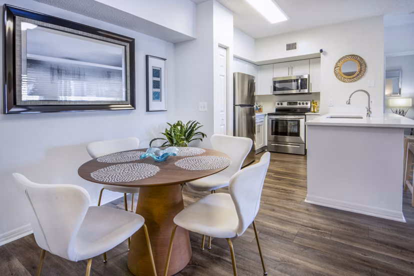 Mira Flores Apartments: Elegant dining room with designer lighting and modern furnishings, ideal for upscale living