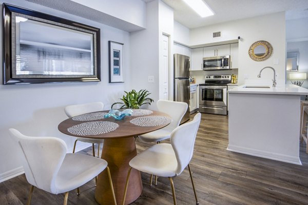 Mira Flores Apartments: Elegant dining room with designer lighting and modern furnishings, ideal for upscale living