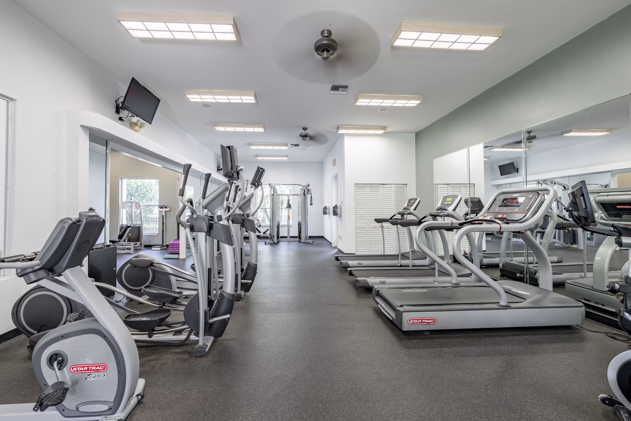 State-of-the-art fitness center with modern equipment at Mira Flores Apartments