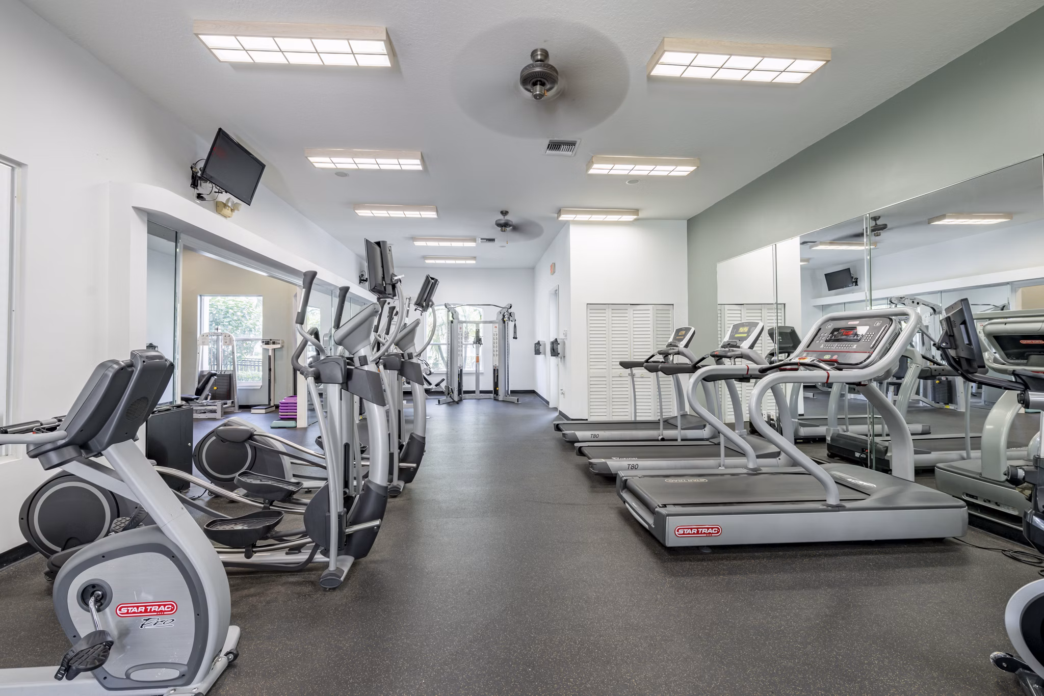 State-of-the-art fitness center with modern equipment at Mira Flores Apartments