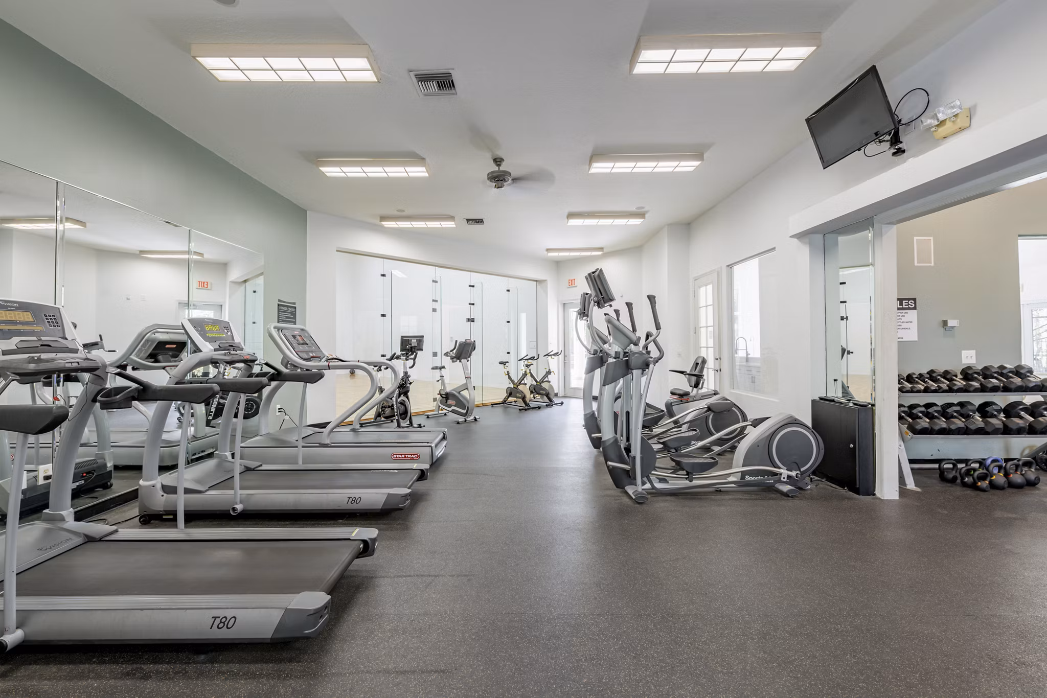 Modern fitness center with state-of-the-art equipment at Mira Flores Apartments