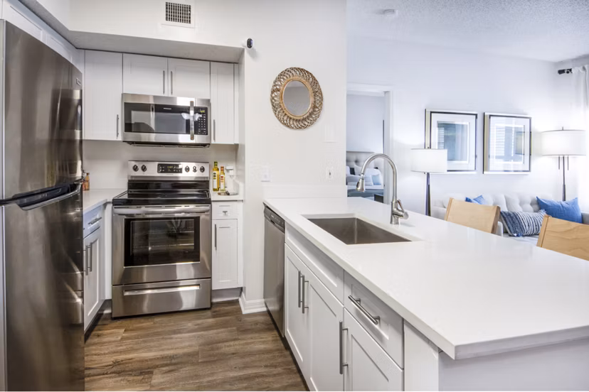 Modern kitchen with sleek countertops and stainless steel appliances at Mira Flores Apartments
