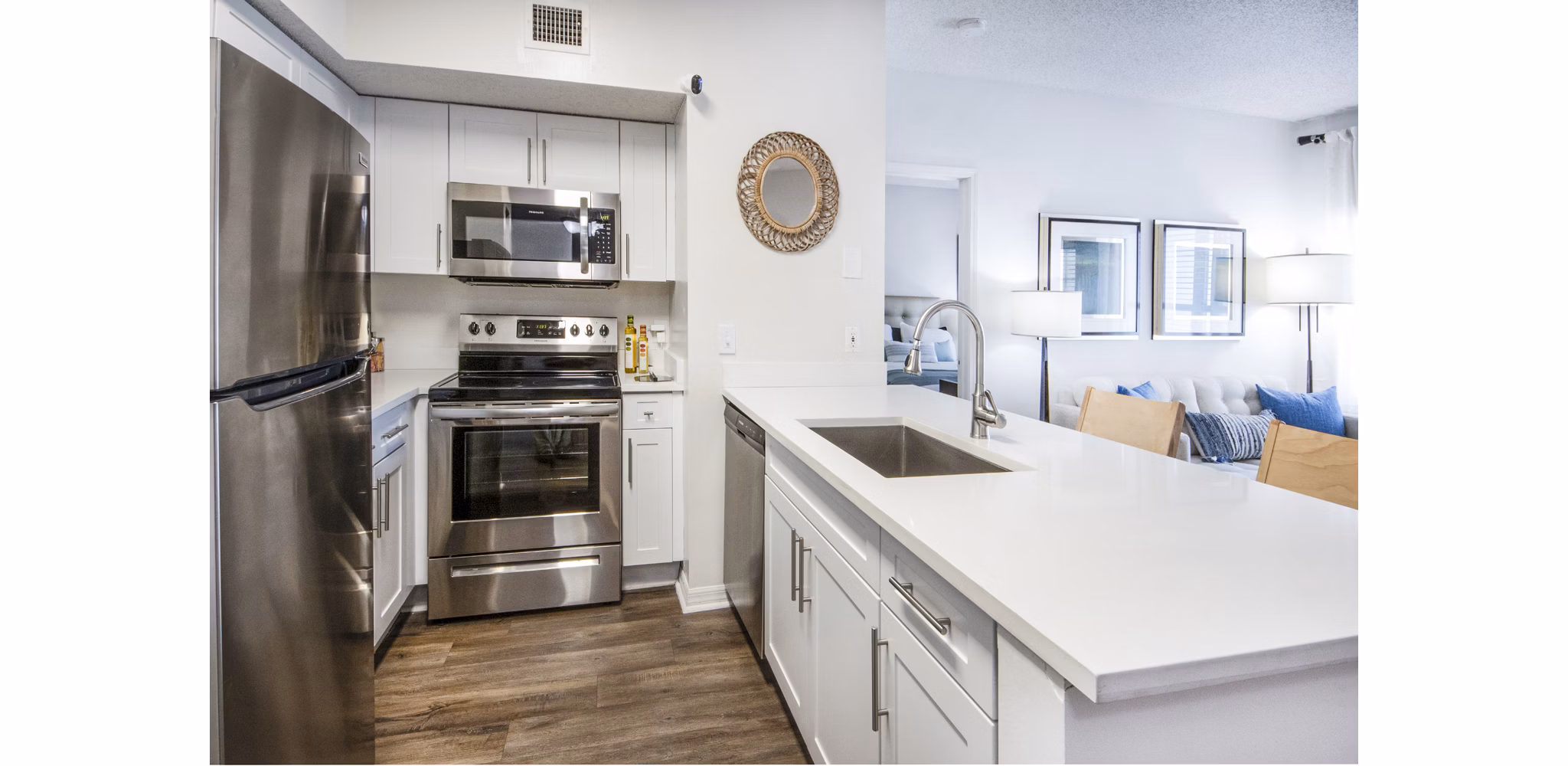 Modern kitchen with sleek countertops and stainless steel appliances at Mira Flores Apartments