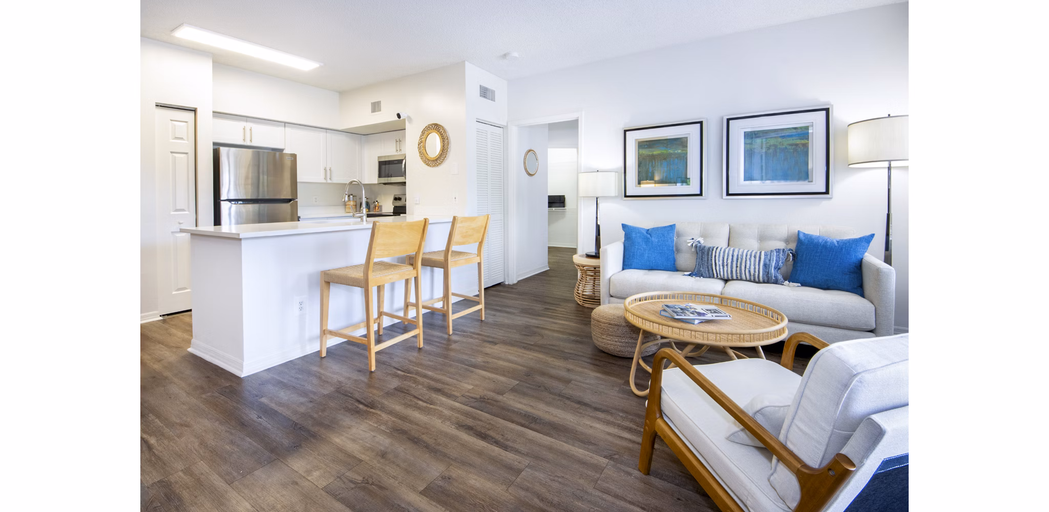 Spacious living room with sleek furniture and natural lighting in Mira Flores Apartments, luxury Greystar property