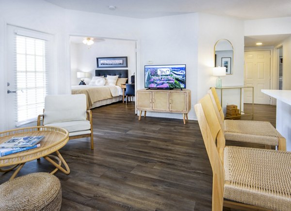 Spacious living room with modern decor and large windows at Mira Flores Apartments