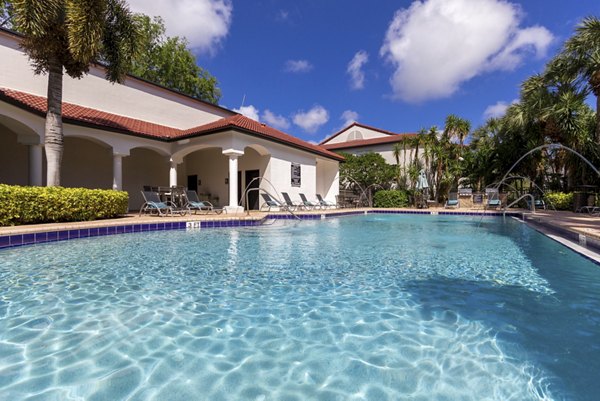 Luxury pool with lounge chairs at Mira Flores Apartments